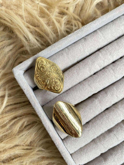 Two Pyakha Angu Rings on a textured surface with fur background