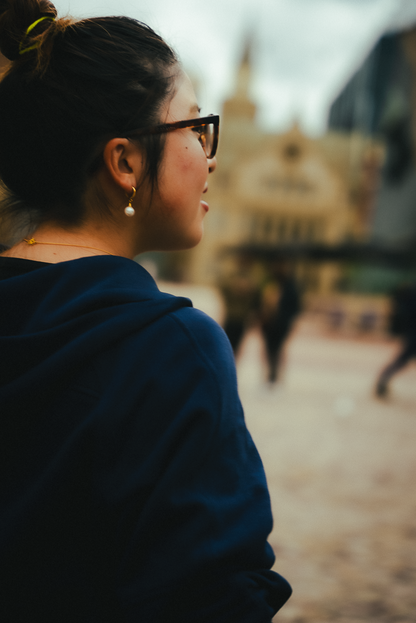 Pearl hoops styled on model showing refined elegance - exquisite pearl earrings for everyday wear