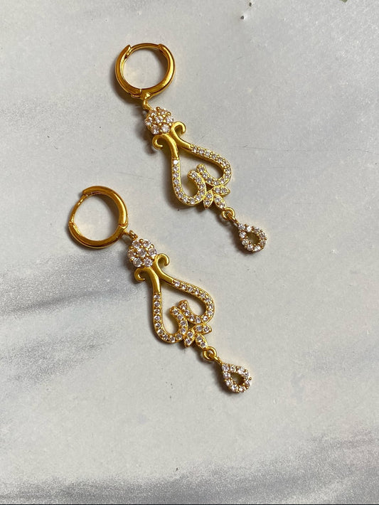 Ashwini Earrings with intricate designs on a light gray background