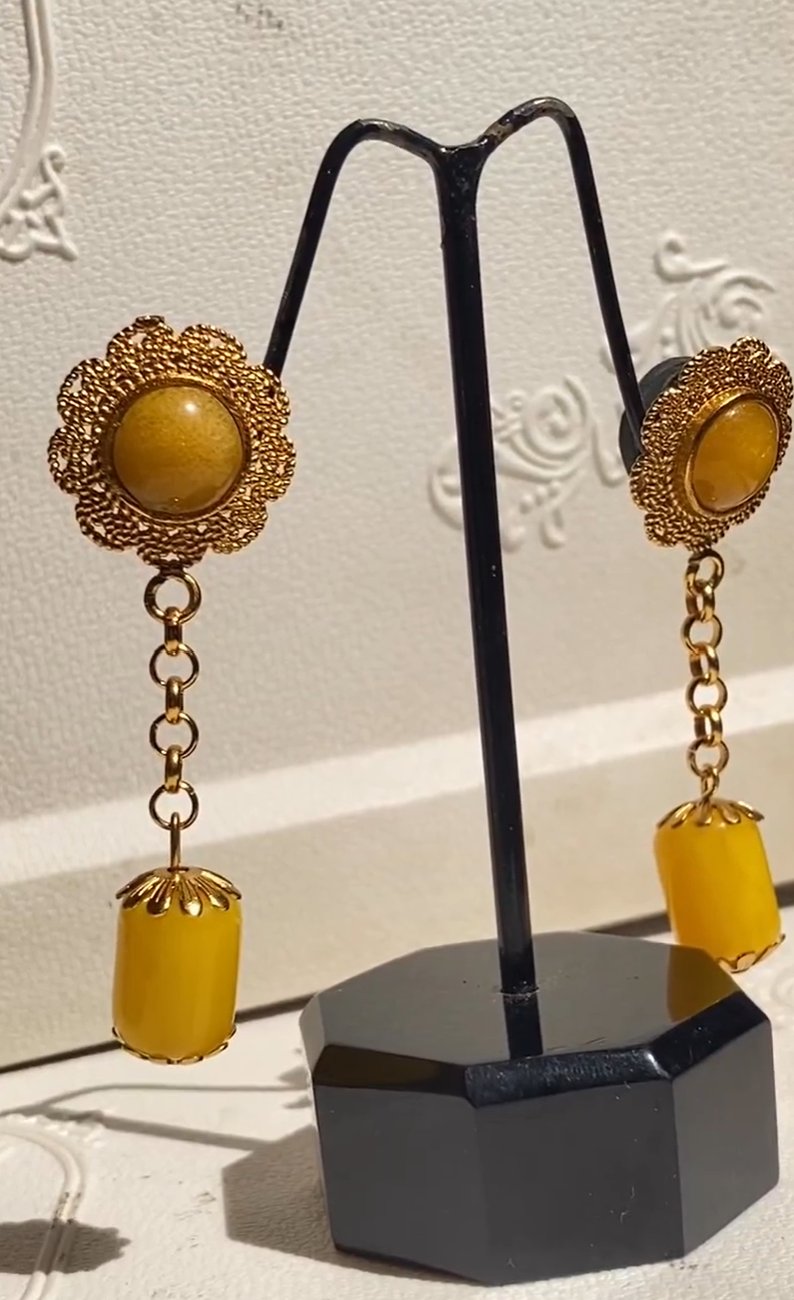 Close-up of golden haldi earrings showing polished sunflower detailing - elegant traditional jewelry