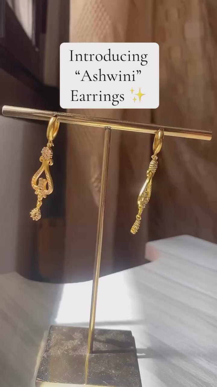 Ashwini Earrings on a earrings stand, and a woman wearing Ashwini Earrings