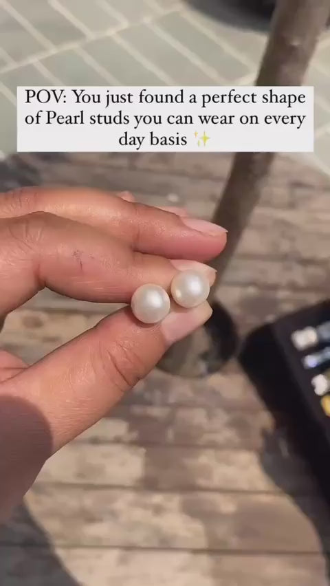 Video of person holding pearl studs